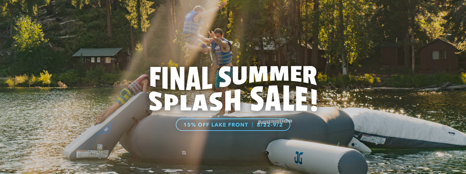 Three people jumping together on inflatable lake platform surrounded by trees and sunlight.