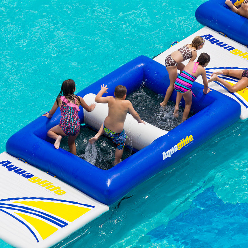 Kids enjoying a Delta 10 inflatable course in the pool.