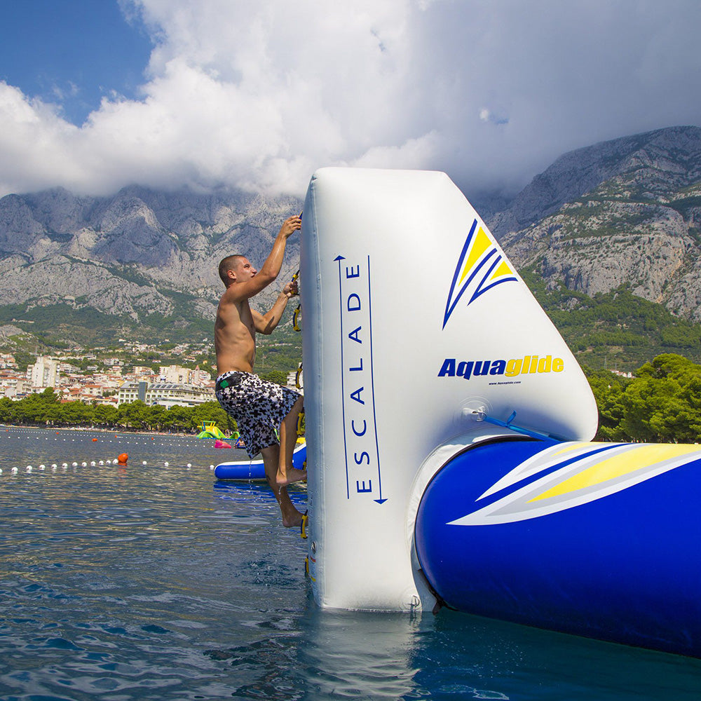 Person on Escalade 3M inflatable climber with mountains in the background.