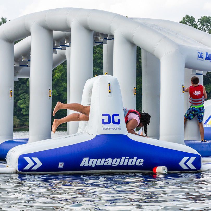 People enjoying the Hatchway 10 inflatable aquapark track with obstacles.