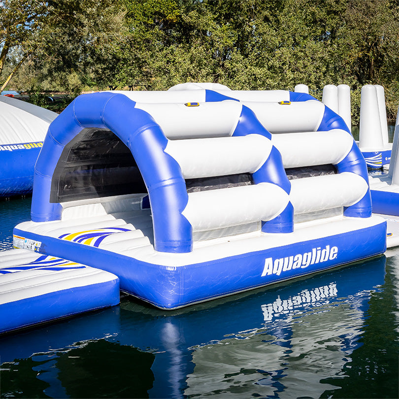 Aquapark has a blue/white Subway 10 inflatable obstacle course on a lake.