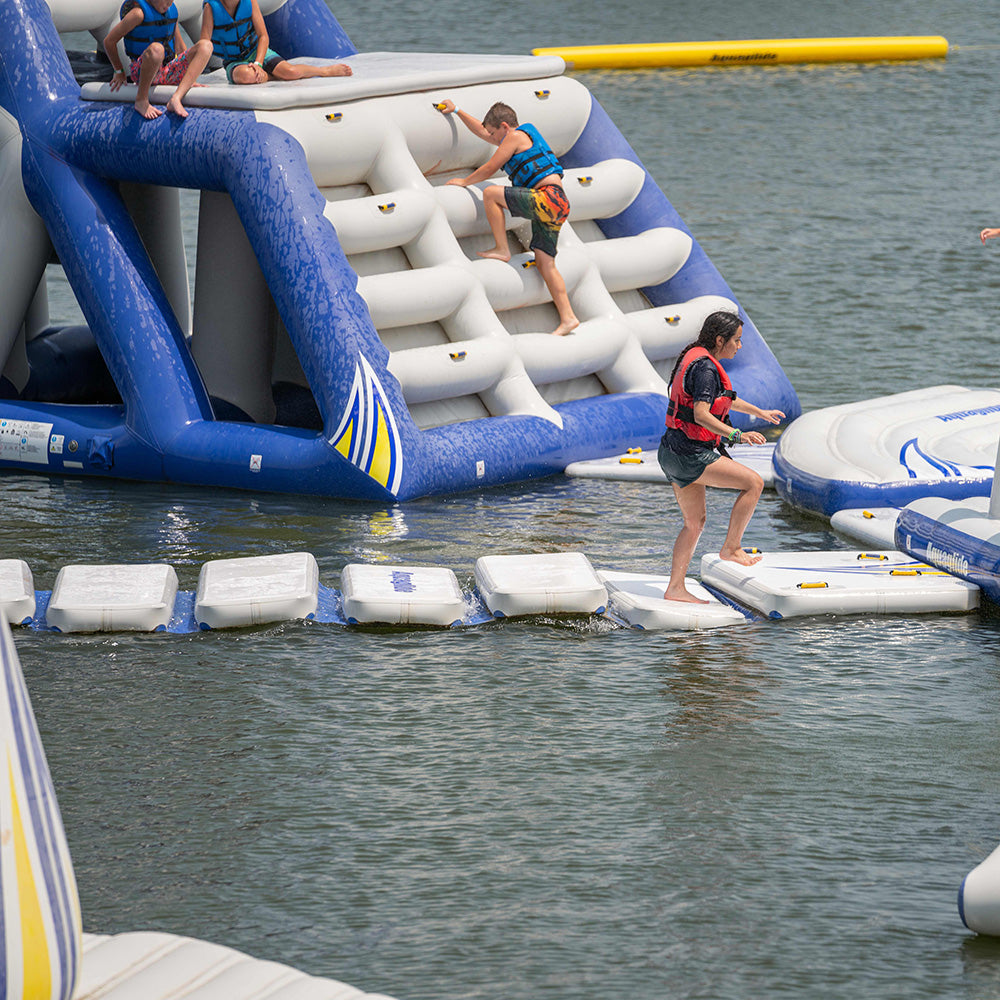 People using a Walk on Water at an aquapark in a lake.