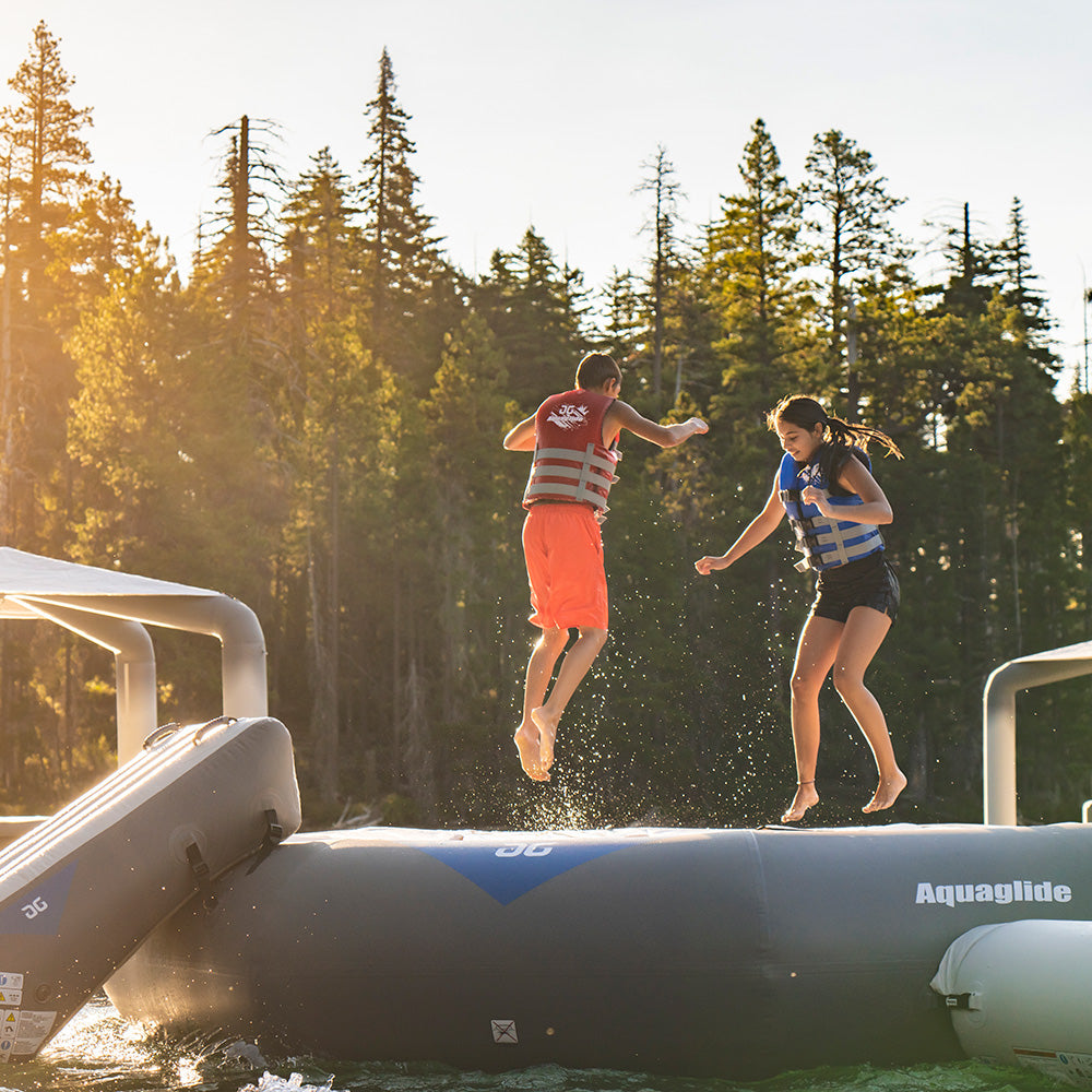 Two people enjoying a Lakefront Mini Park 5 on a forested lake.