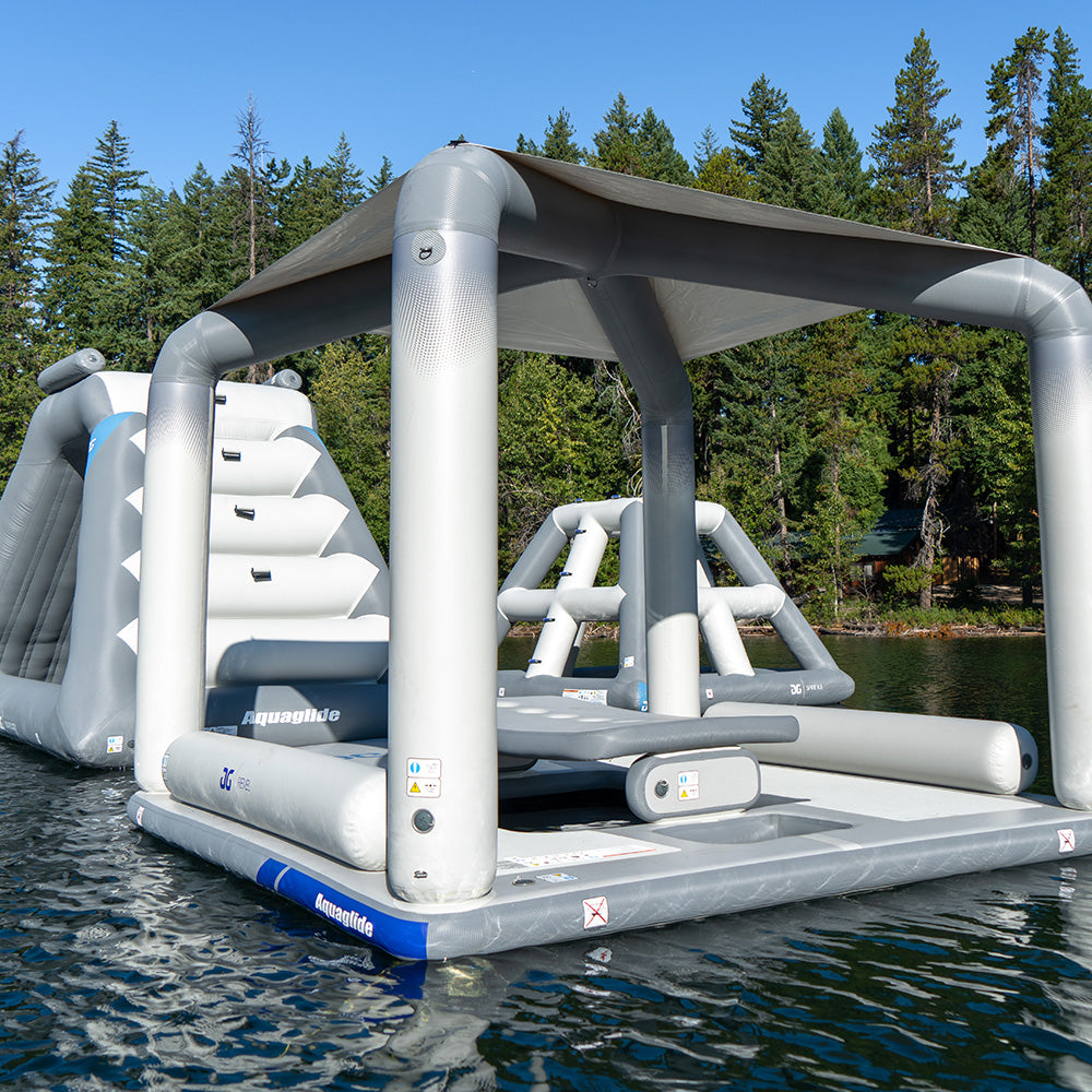 The Lakefront Mini Park 6 floats on a lake surrounded by trees.