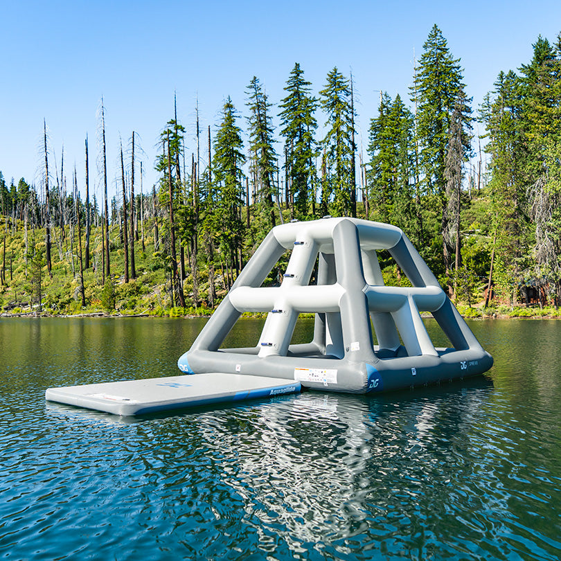 Spire 6.8 inflatable play structure on lake with forest view.