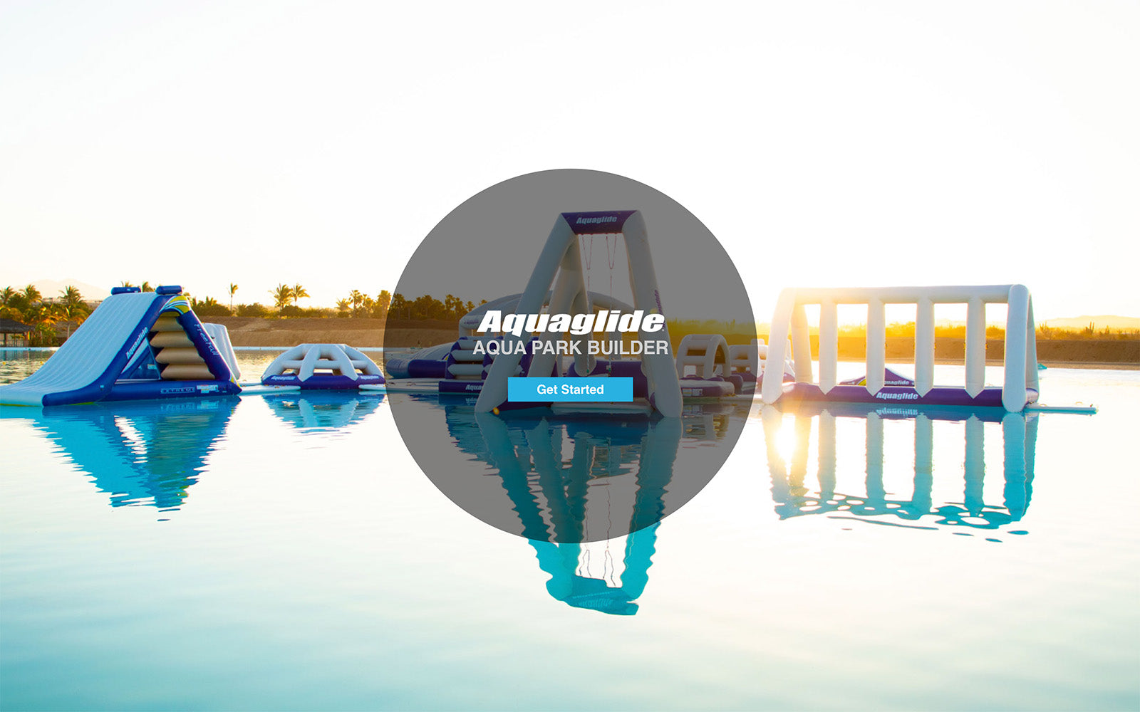 Inflatable water park structures on a calm lake under a clear sky.