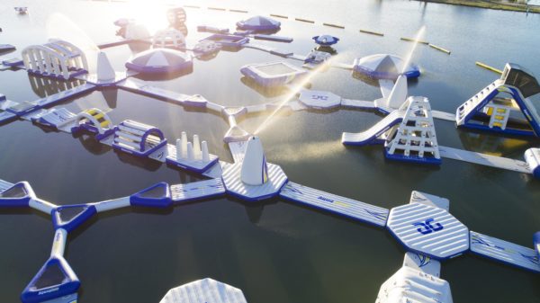 Universal Monsoon Spray Station: Inflatable course design on a sunny, calm lake.