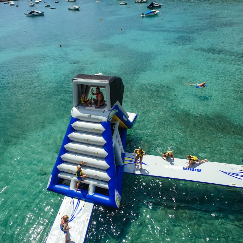 Overview of the Freefall Supreme with 7 people climbing, and waving to the camera above.