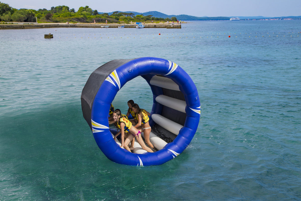 People in life jackets inside a Cyclone Wheel roll on water.