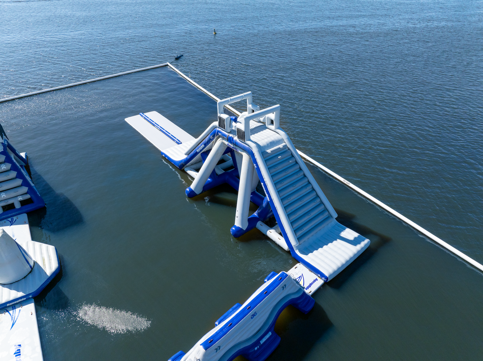 Aquaglide slide with dual lanes leads into a large open swim area.