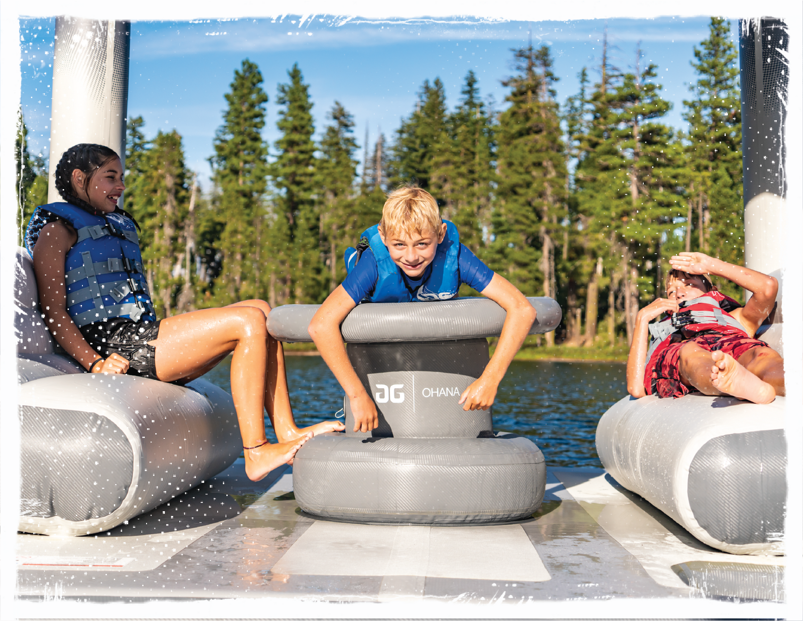 Kids relaxing on an Ohana from Aquaglide; inflatable, floating and shaded lounge with plenty of seats and a table.