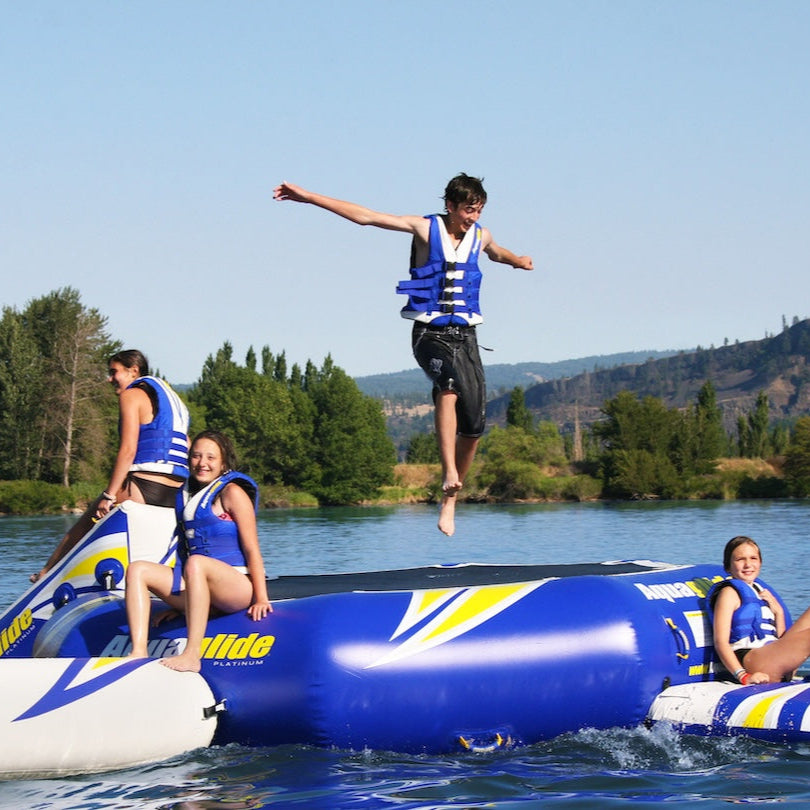 Teen boy jumps off the Rebound 20 while others sit and smile.