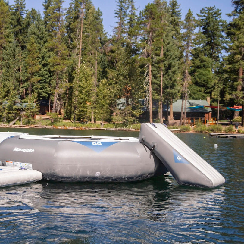 The Large Ricochet / Recoil Slide on a lake, shown attached to other inflatable features.