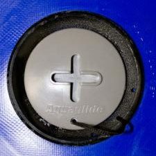 Close-up of a Safety Valve Cap with a plus sign on blue material.