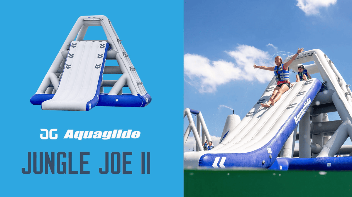 Person sliding down an inflatable slide, arms raised, at the Jungle Joe 2 TR Aquapark.