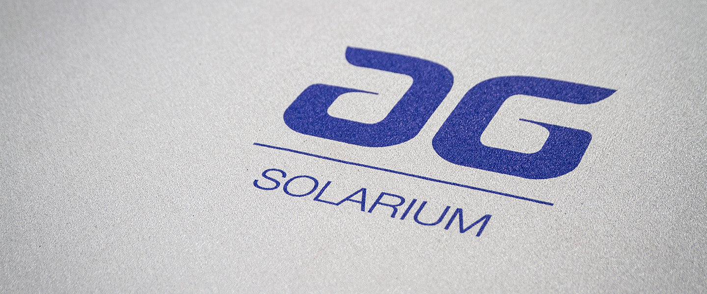 AG Solarium logo in bold blue letters on a light-colored background.