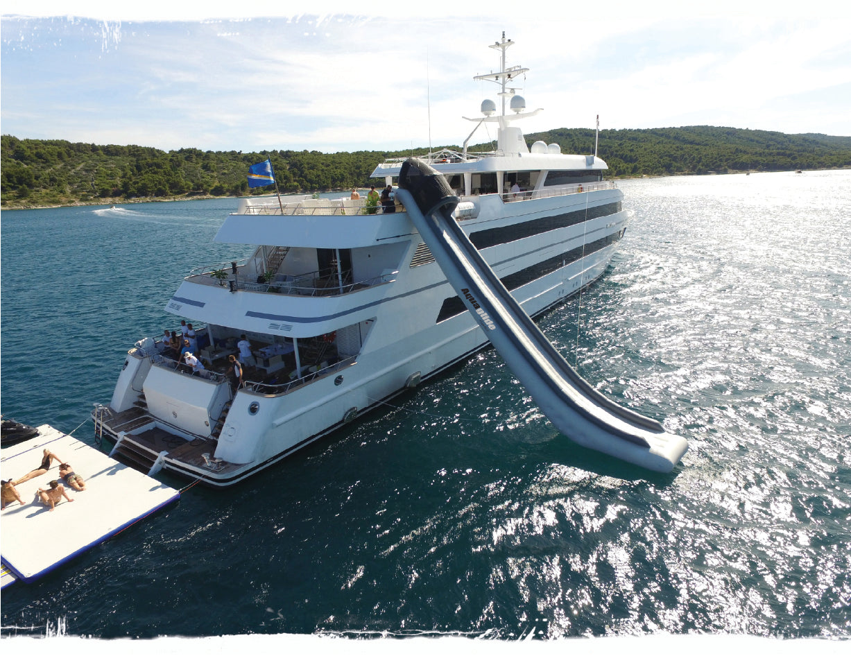 An aquaglide inflatable slide on the side of a yacht