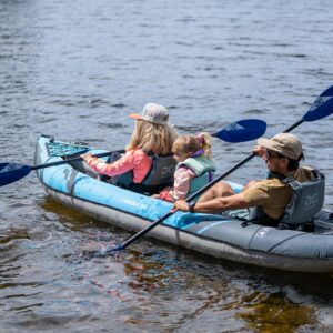 A couple and their child paddle the Chinook 120