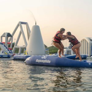 A girl pushes her friend off the top of the bendback, captured right before they fall into the water