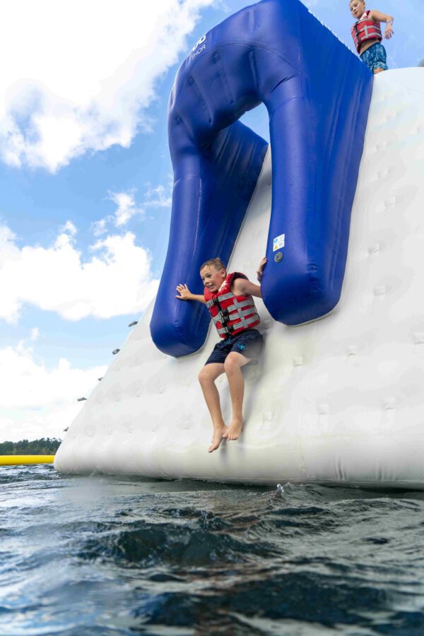 Young boy slides down the Thor side chute, shot from the water